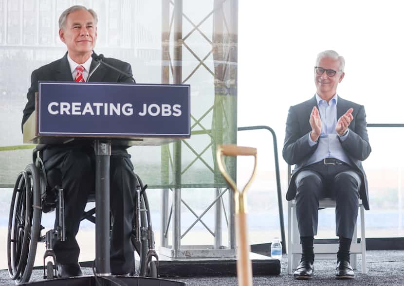 Texas Gov. Greg Abbott (left) pauses his speech at the groundbreaking ceremony for a new...