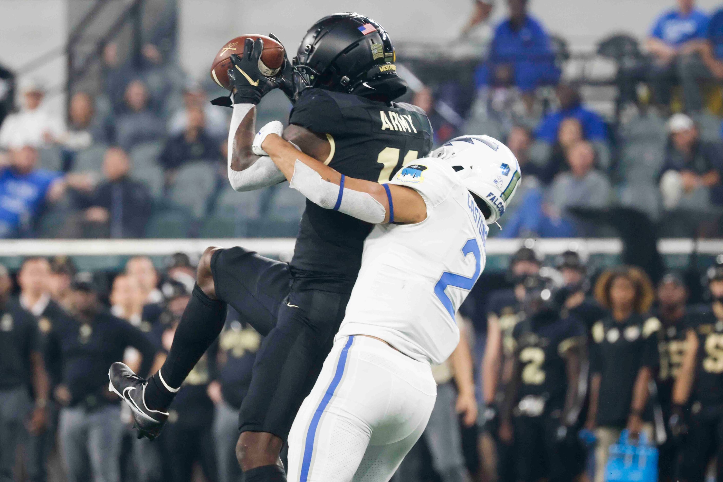 Army wide receiver Isaiah Alston (11), left, receives a pass as Air Force cornerback Eian...