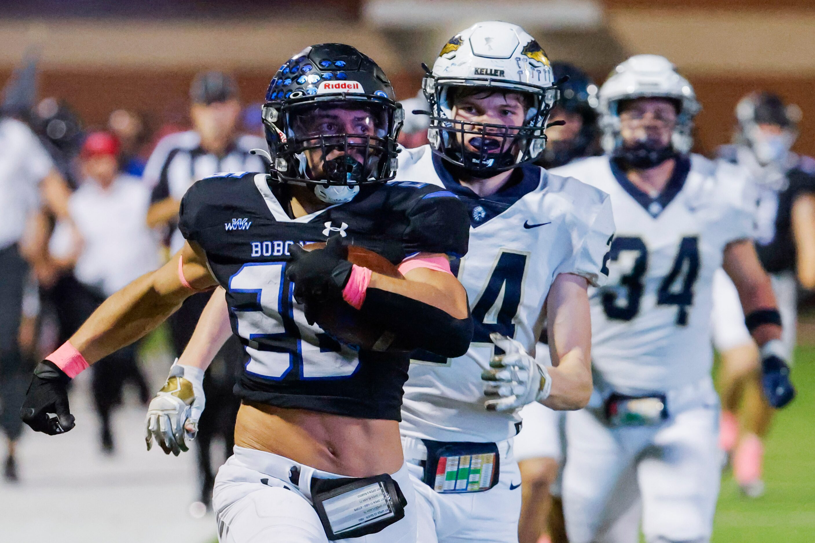 Byron Nelson’s Tucker James (26) runs past Keller high’s TJ Worthy (24) as he scores a...