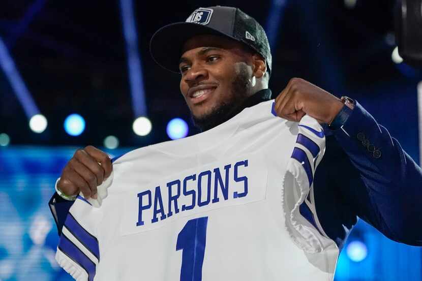 Penn State linebacker Micah Parsons holds a team jersey after the was chosen by the Dallas...