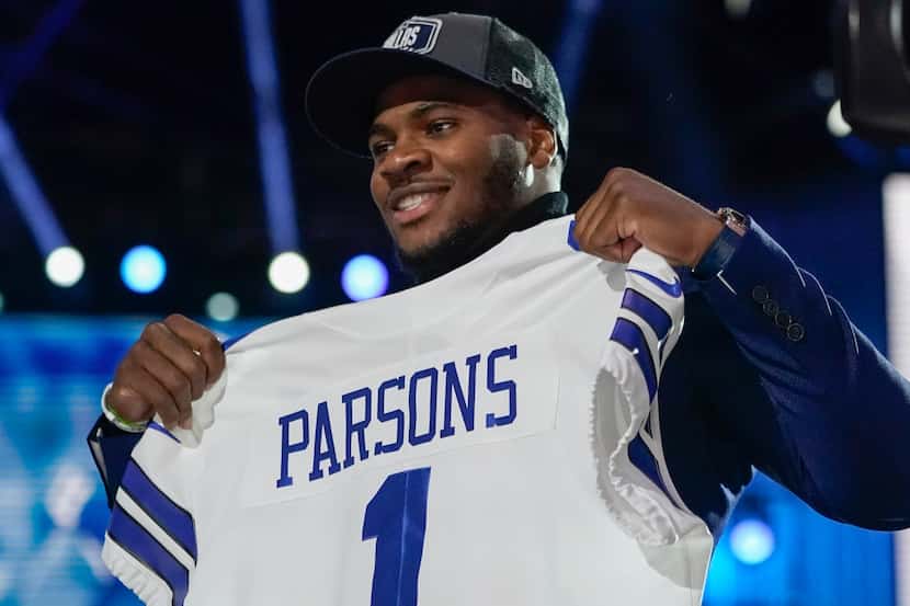 Penn State linebacker Micah Parsons holds a team jersey after the was chosen by the Dallas...