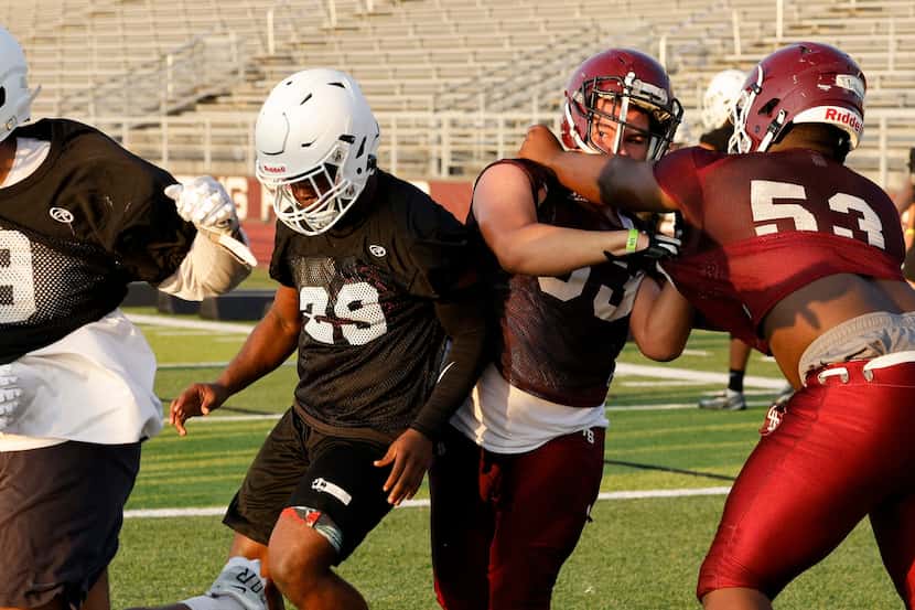 Lewisville players practice blocking during the first day of practice at Max Goldsmith...
