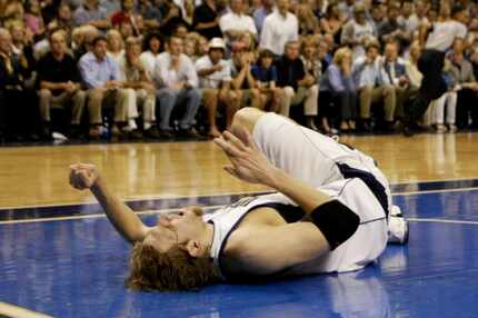 Dirk Nowitzki goes down after twisting his left knee in the fourth quarter in Game 3 of the...