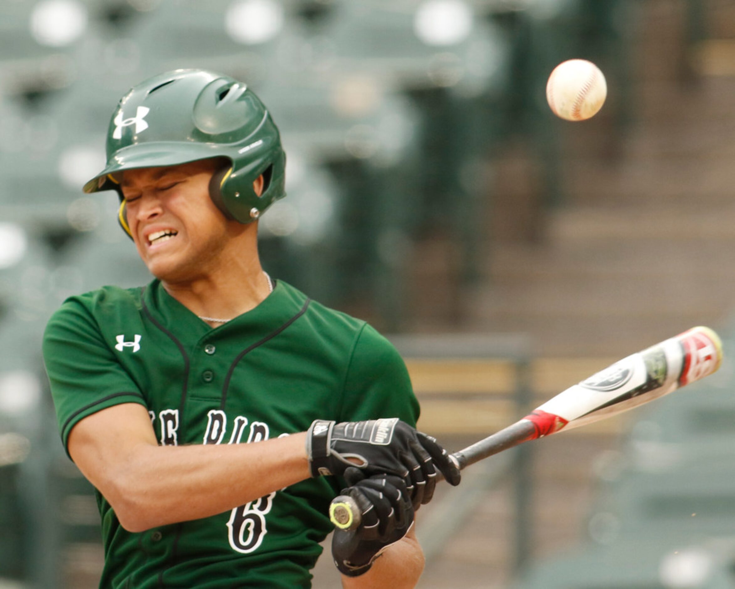 Mansfield Lake Ridge infielder Talon Simmons (6) winces after fouling a pitch off his foot...