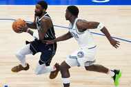 Dallas Mavericks guard Kyrie Irving (11) blows past Minnesota Timberwolves guard Anthony...