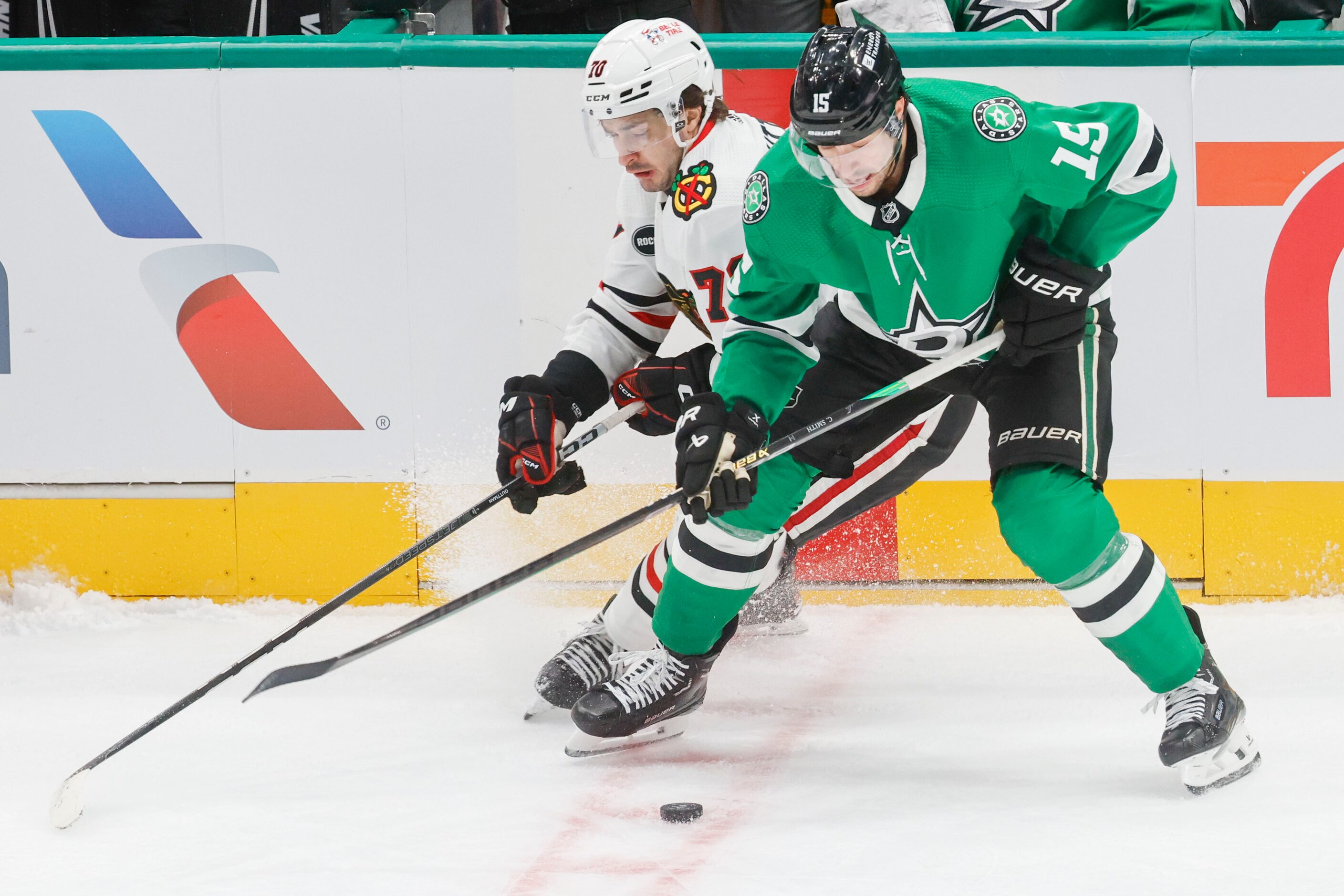 Chicago Blackhawks center Cole Guttman (left) and Dallas Stars center Craig Smith (15)...