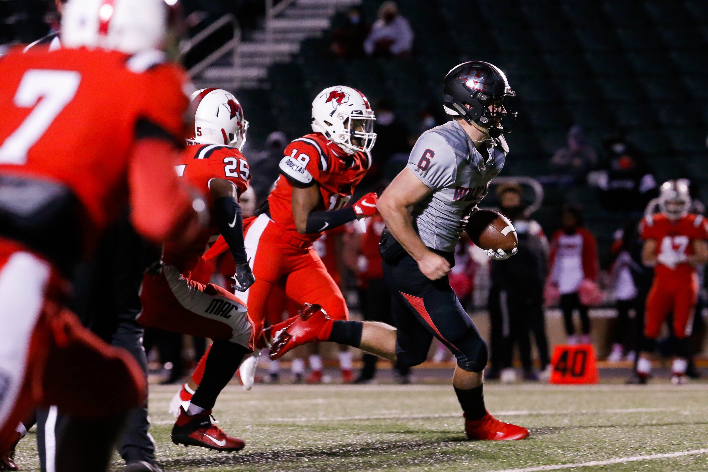 Lake Highlands quarterback Mitch Coulson (6) slips past the Irving MacArthur defense for a...