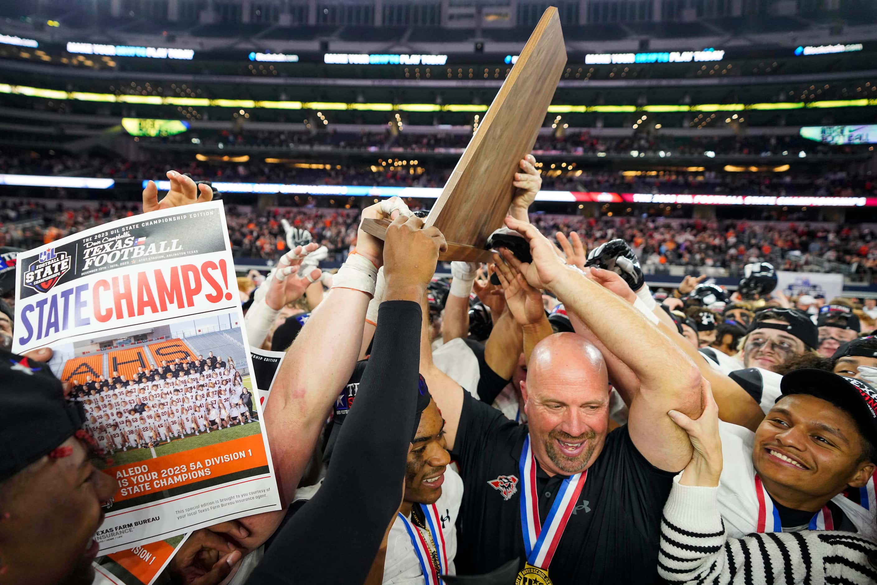 Aledo head coach Robby Jones lifts the championship trophy after a victory over Comal...