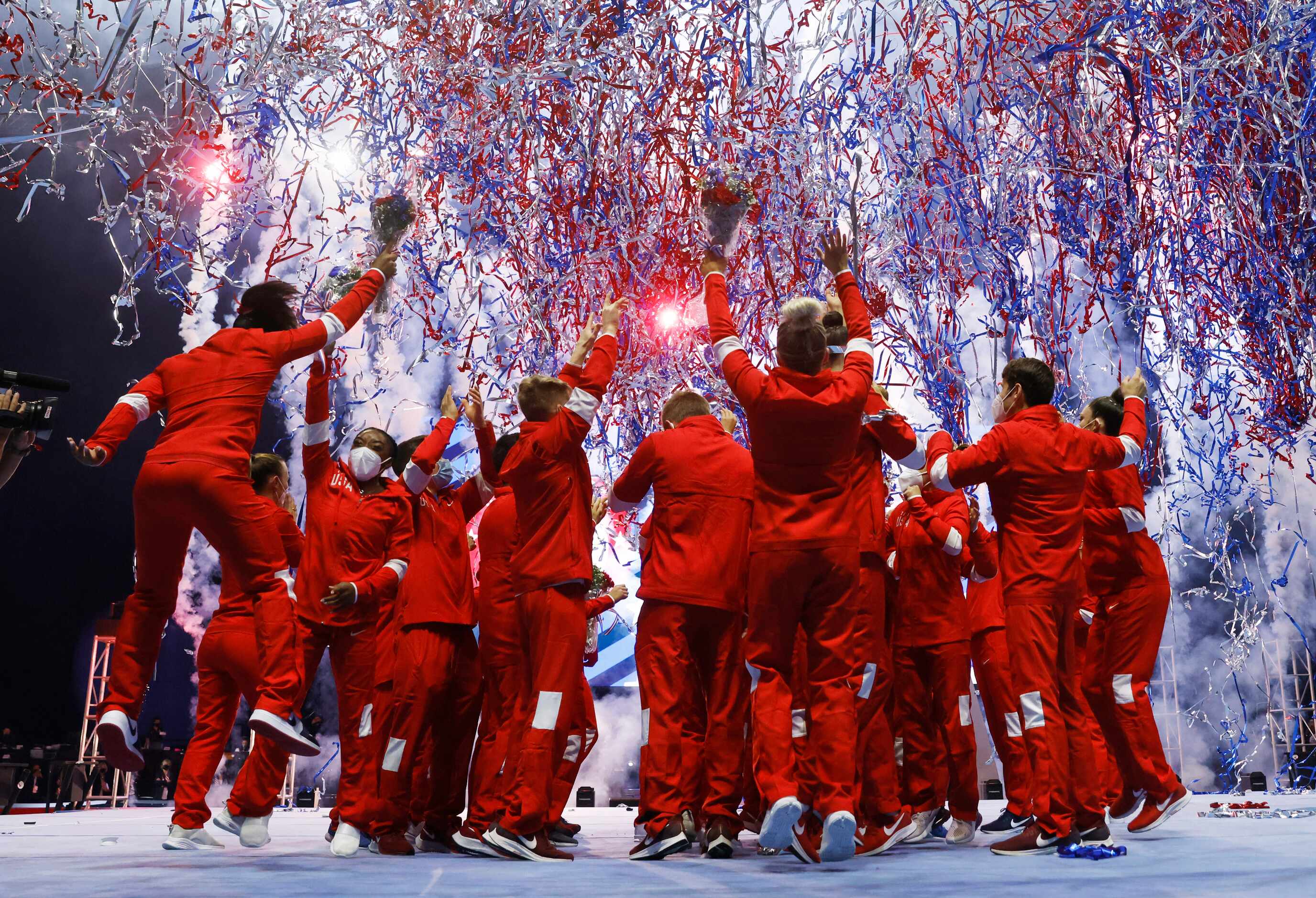 The men's and women's U.S. Olympic gymnastics team celebrate after the women's team was...