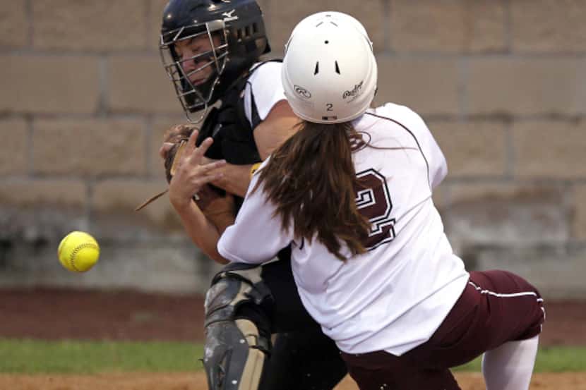 Forney catcher Krista Williams looses the handle on the ball as Ennis baserunner Courtlyn...