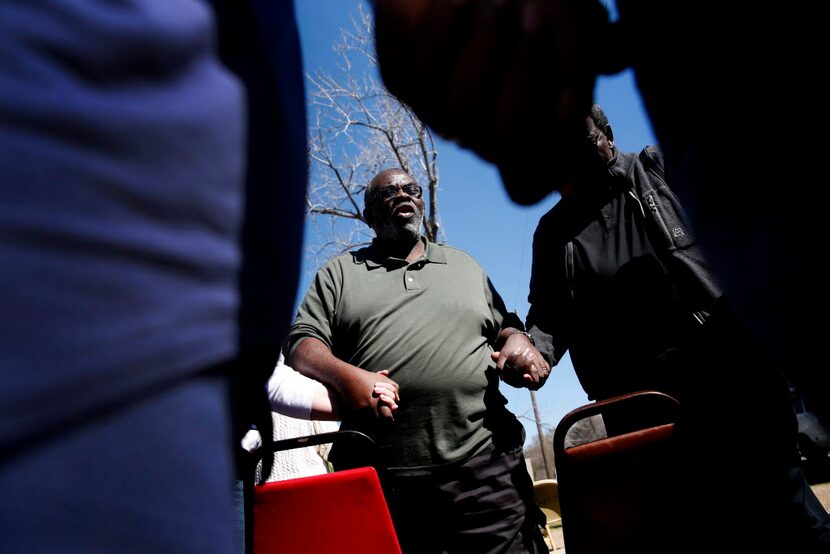  Jerry Jones, a member of Cornerstone Baptist Church, leads a prayer circle in the...