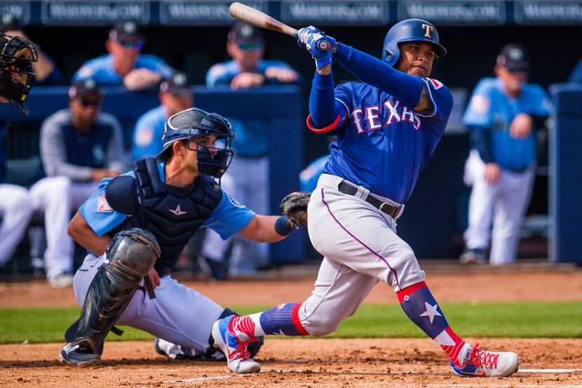 Texas Rangers outfielder Willie Calhoun bats during the second inning of a spring training...
