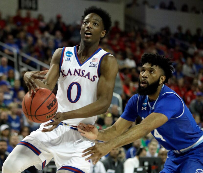 Kansas guard Marcus Garrett (0) drives past Seton Hall guard Eron Gordon (4) during the...