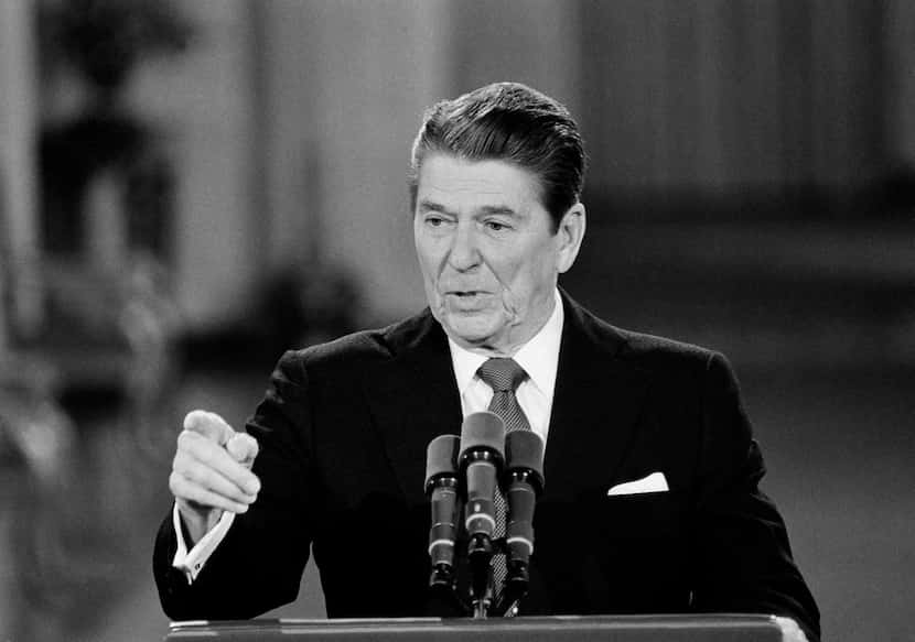 This April 4, 1984 black-and-white file photo shows President Ronald Reagan faces reporters...