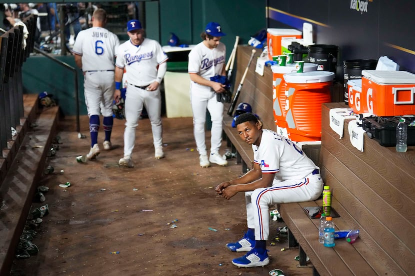 Texas Rangers relief pitcher Jose Leclerc sits in the dugout after a loss to the Houston...