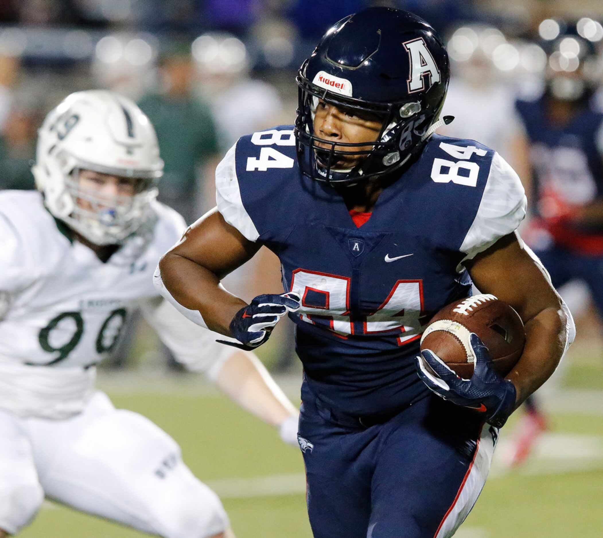 Allen High School wide receiver Grant Robinson (84) carries the ball for a good gain during...