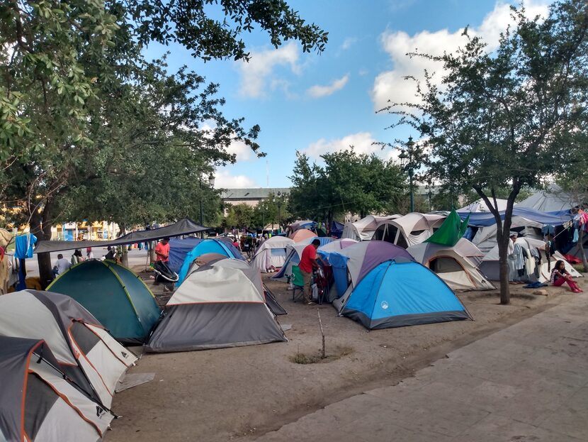 Migrants gather in tents in a downtown park in Reynosa, Mexico, across from Hidalgo. The...