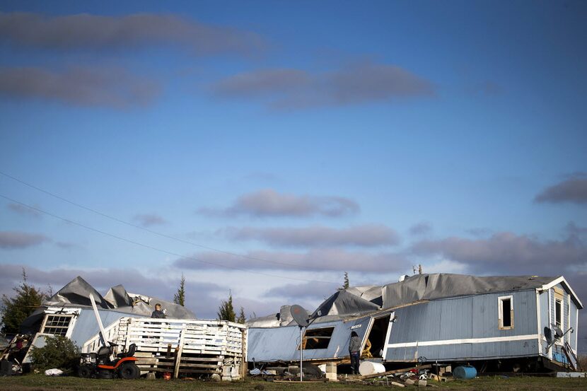  People pick through the rubble of the Santillano's destroyed home in Blue Ridge. (Smiley N....