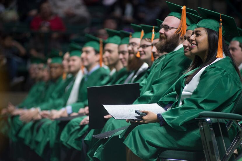 UNT students listen during a speech at their graduation ceremony. UNT's College of...