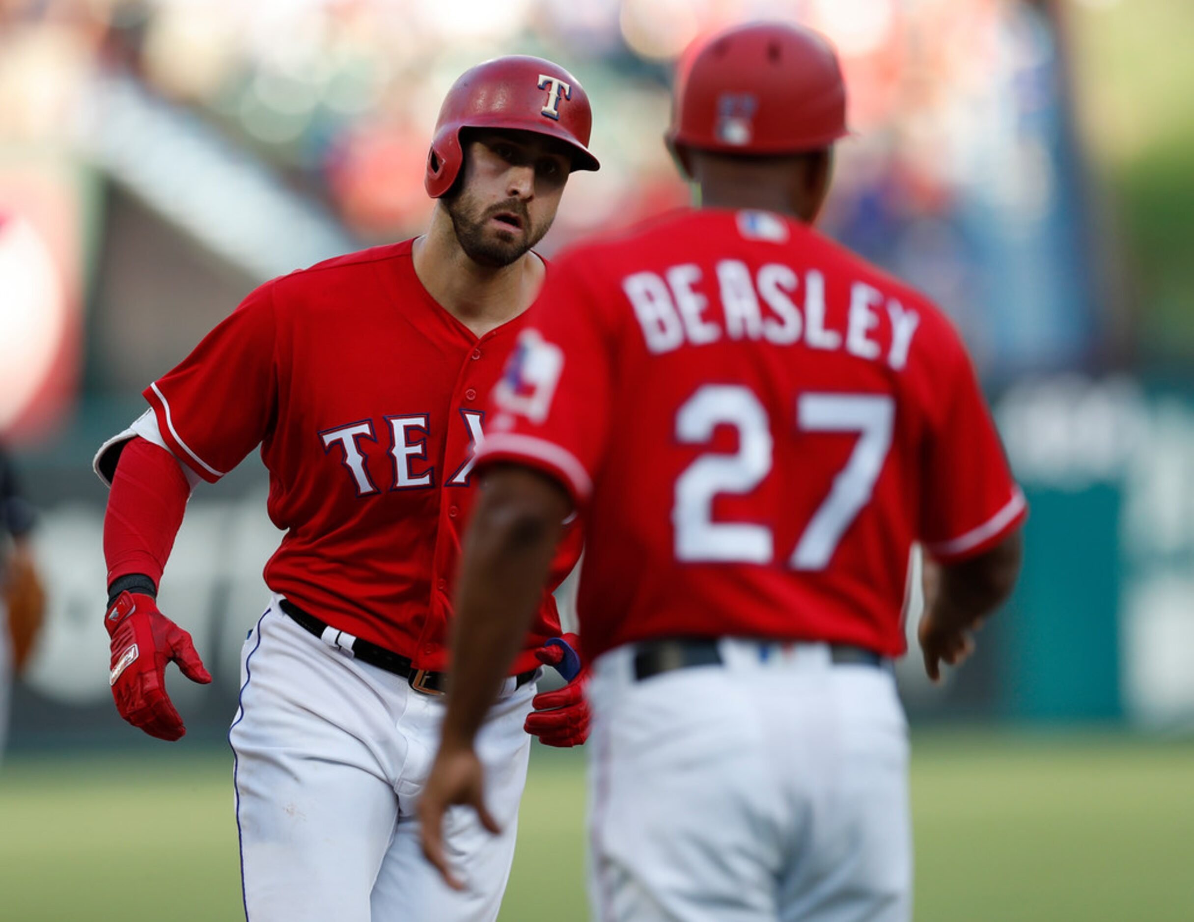 Texas Rangers' Joey Gallo, left, celebrates his two-run home run with third base coach Tony...