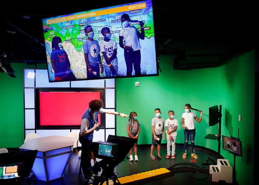 Kids stand before green screen as they deliver the weather forecast in a kid-sized WFAA...