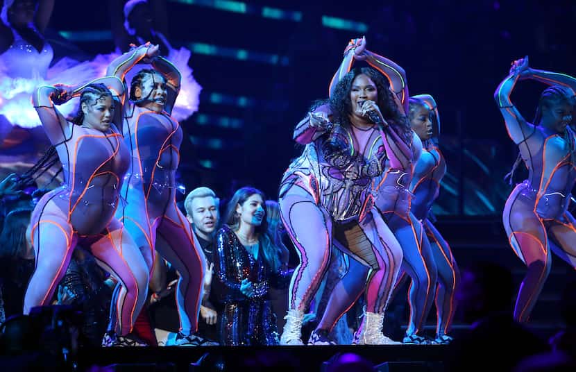 Lizzo, center, performs at the 62nd annual Grammy Awards on Sunday, Jan. 26, 2020, in Los...