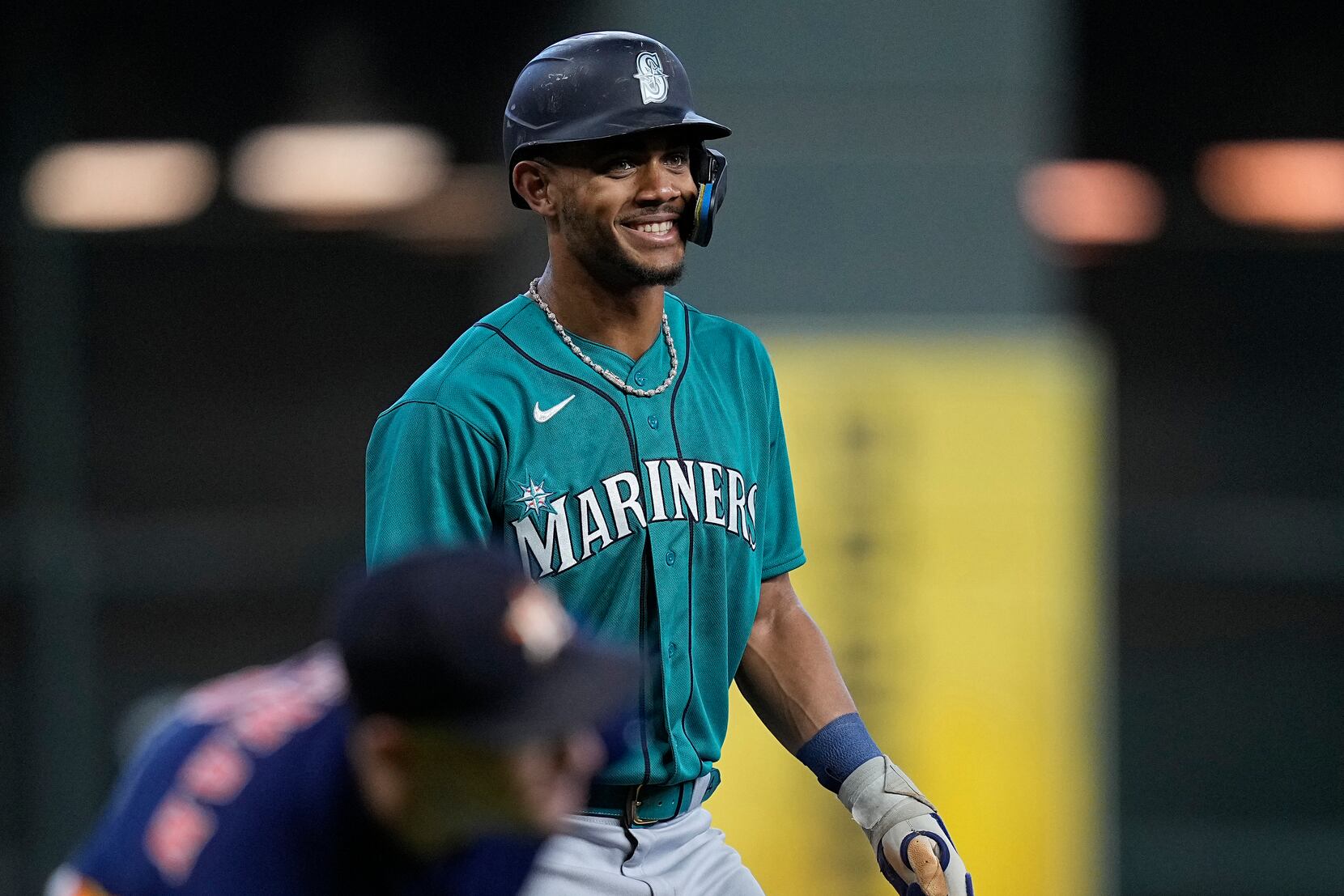 Seattle Mariners' Julio Rodriguez smiles as he talks with a fan