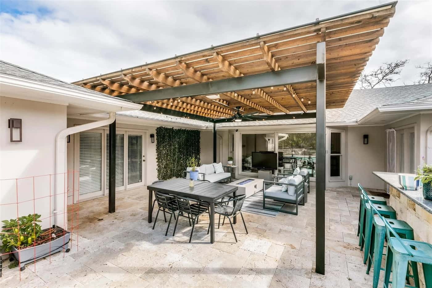 Patio seating area covered with a pergola.