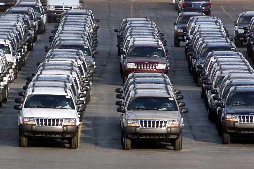 FILE - In this file photo taken Fed. 2, 2001, rows of 2001 Jeep Grand Cherokees are lined up...