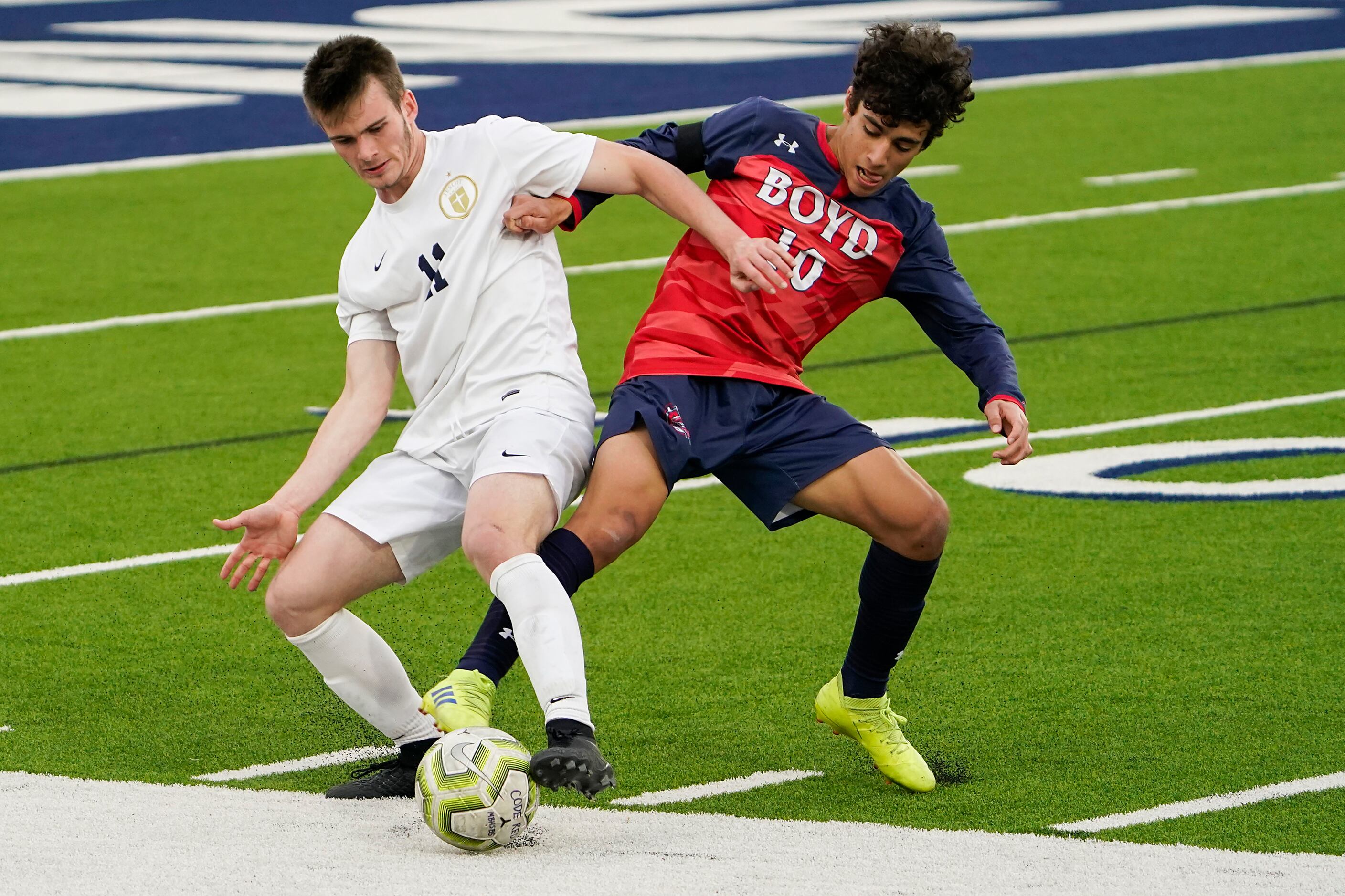 Jesuit forward Ryan Shea (11) battles for possession of the ball with McKinney Boyd...