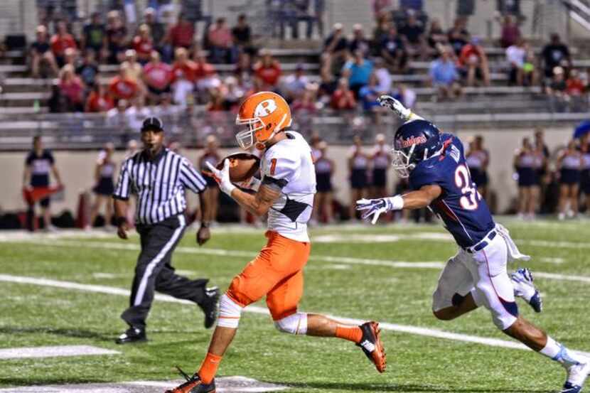 
Rockwall receiver Jay Galloway (1) hauls in his second touchdown catch against Denton Ryan...