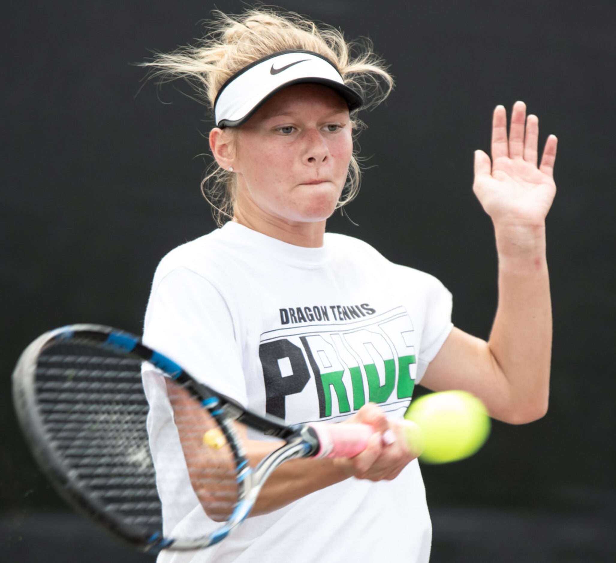 Southlake Carroll's Kelly Kunz returns the ball in a doubles match with teammate Drake Ferri...