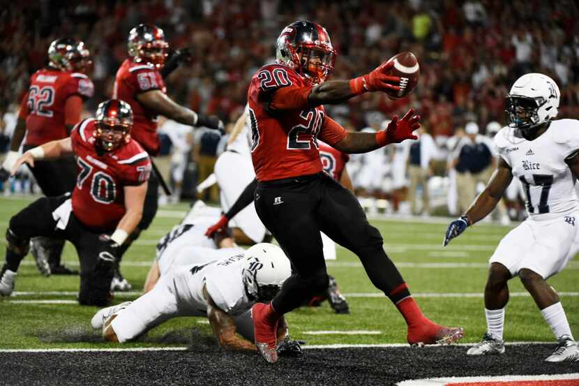 Western Kentucky's Anthony Wales (20) runs in a touchdown during the first half of an NCAA...