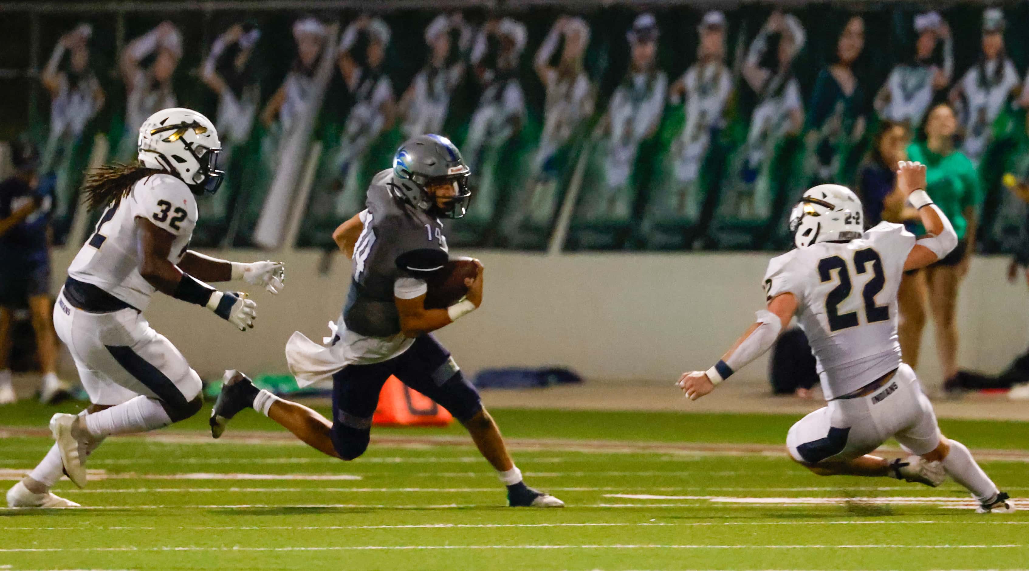 V.R. Eaton High School quarterback Noah Lugo (14) dodges Keller High School defense during...
