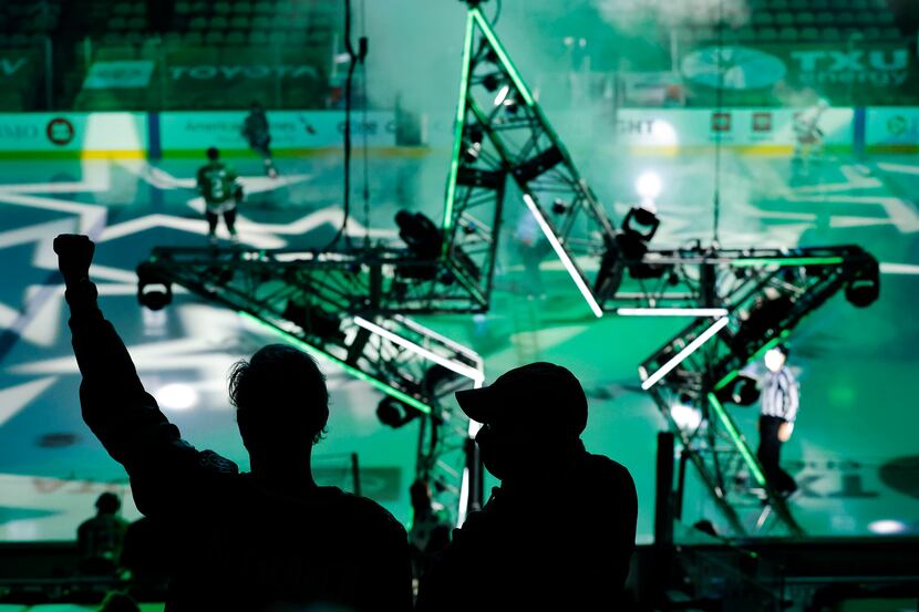 Dallas Stars fans cheer their players as they're introduced during the last home game of the...