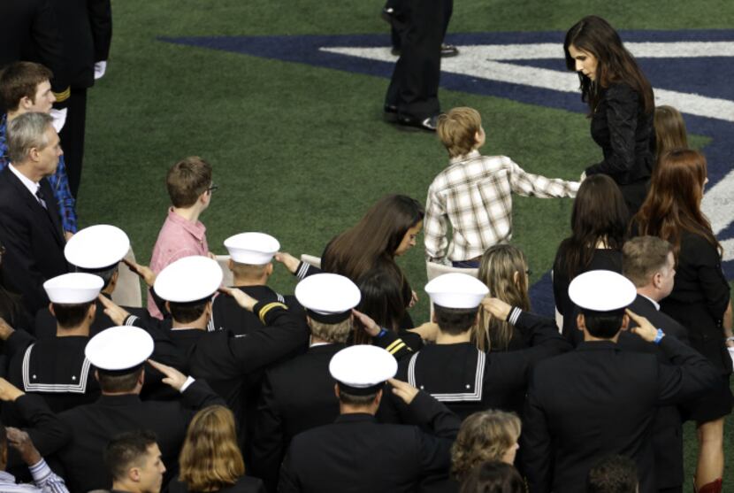 Taya Kyle far right, leads her two children to their seats at the beginning of  the memorial...