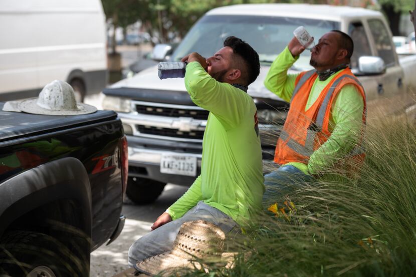 Construction workers Jesus Pineda, left, and Israel Martinez took a water break last summer...