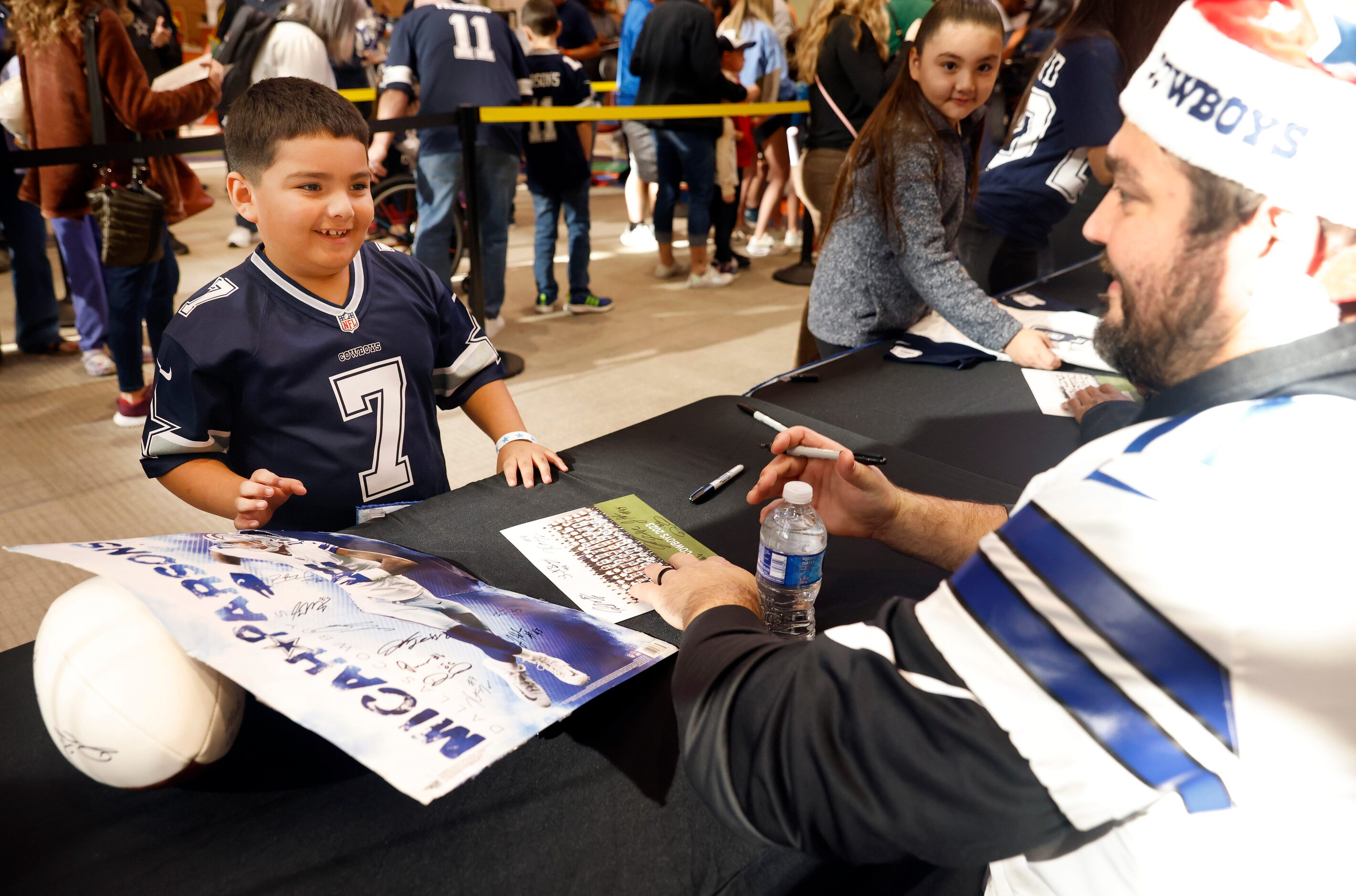 Dallas Cowboys guard Zack Martin (right) signed some autographs for Matthew Bergara, 7, of...