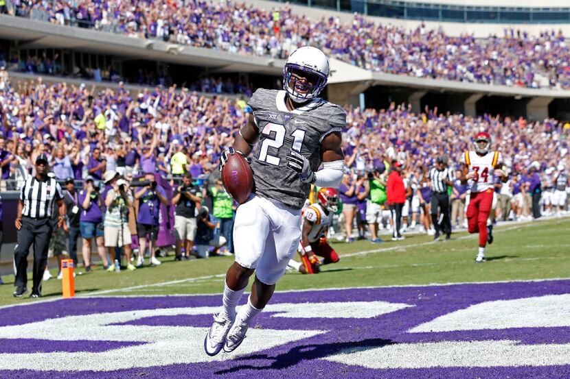 TCU running back Kyle Hicks (21) celebrates after scoring a touchdown against Iowa State...