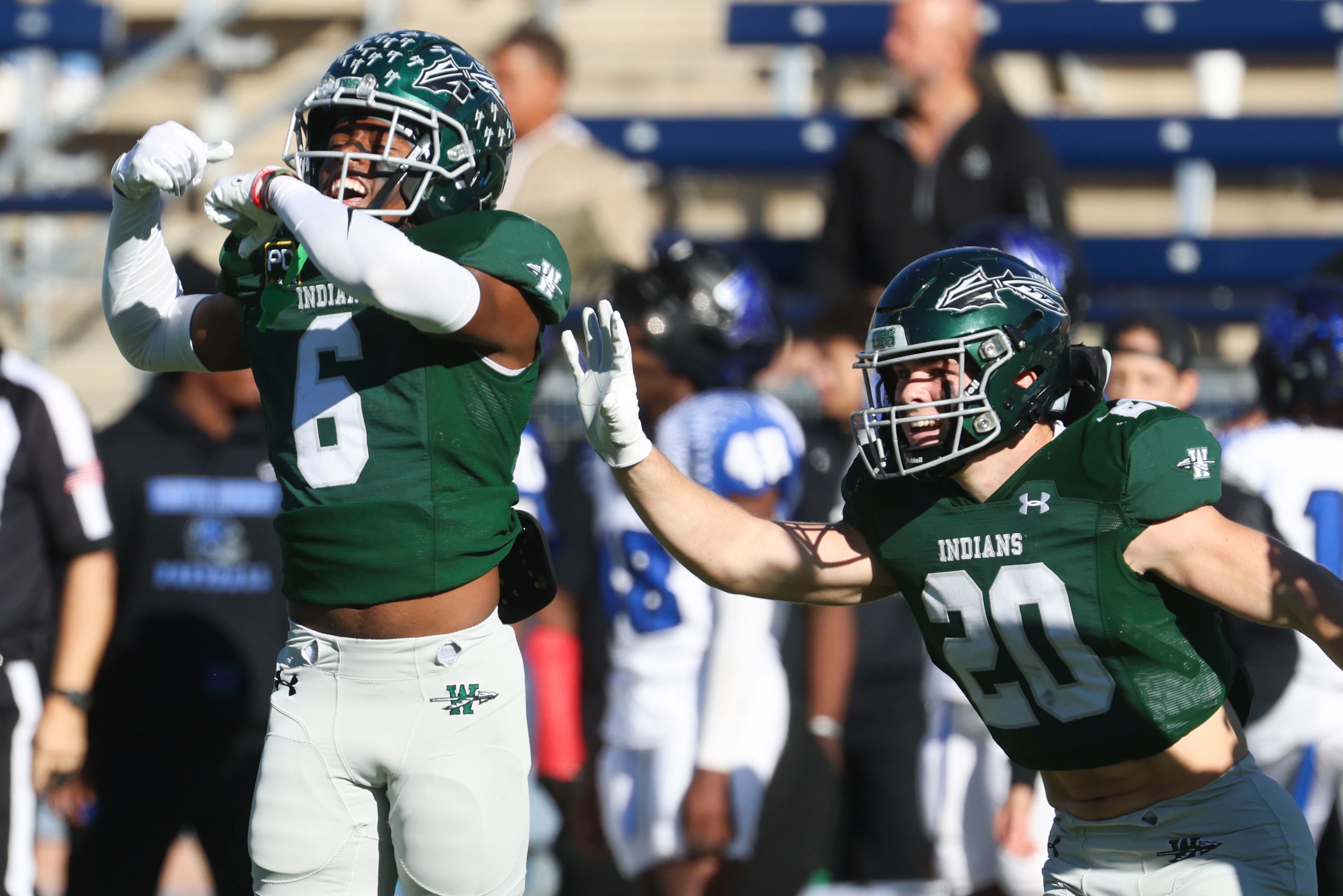 Waxahachie High’s Micah Cook (6) and Kaden Tolleson (20) celebrate following an interception...