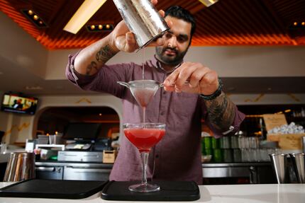 Bar manager Ravinder "Ravi" Singh pours an agave gimlet at Jalisco Norte in Dallas. It's...