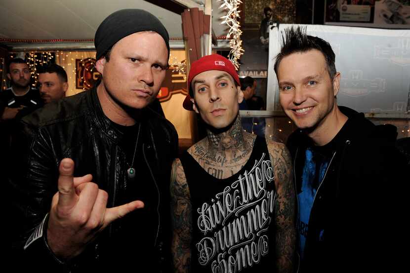 From left, musicians Tom DeLonge, Travis Barker and Mark Hoppus of Blink-182 pose at a press...