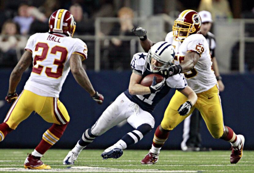 Dallas Cowboys wide receiver Cole Beasley tries to fight off Washington Redskins inside...