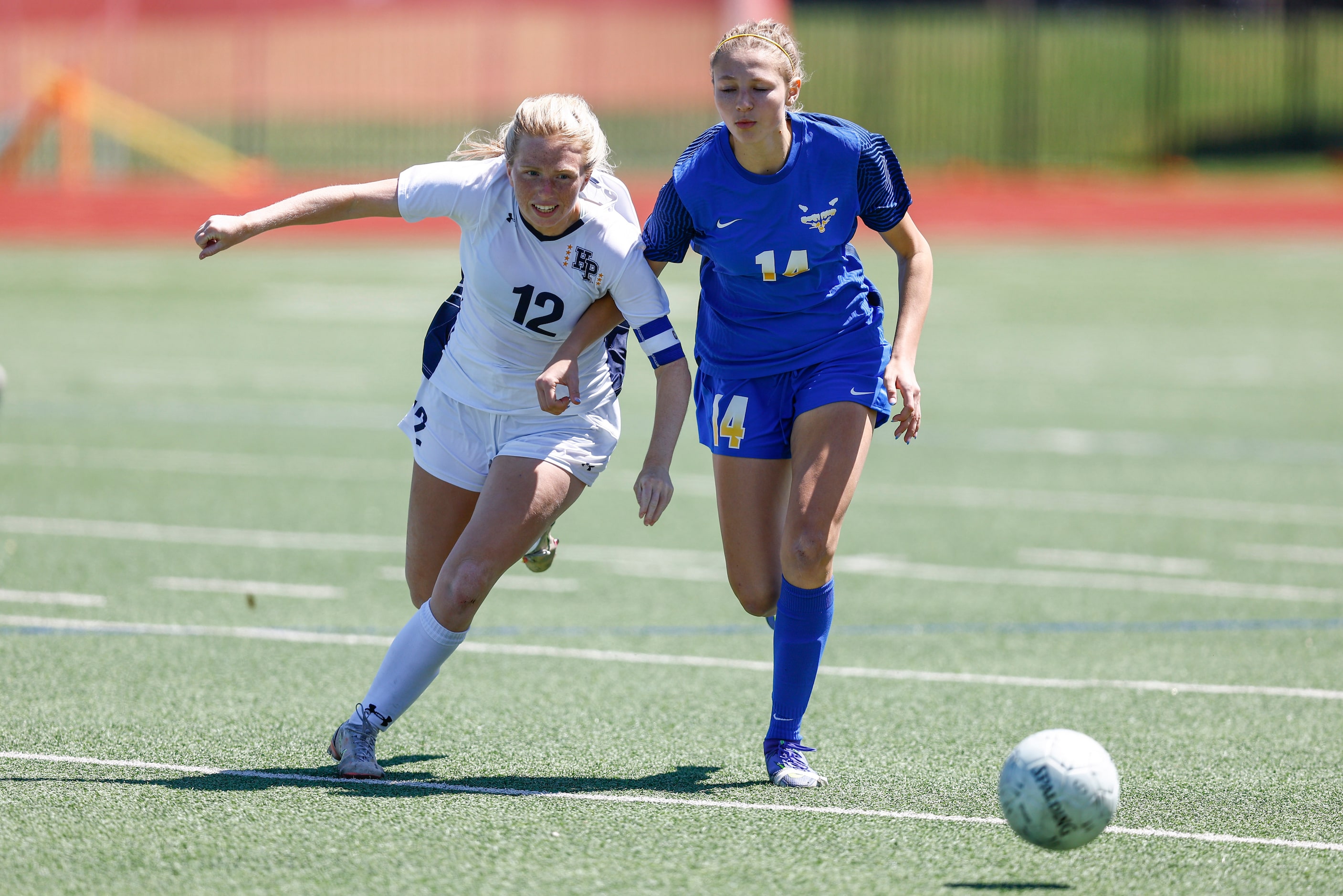 Highland Park’s Kylie Bell (12) and Frisco’s Mallory Rush (14) battle for the ball during...