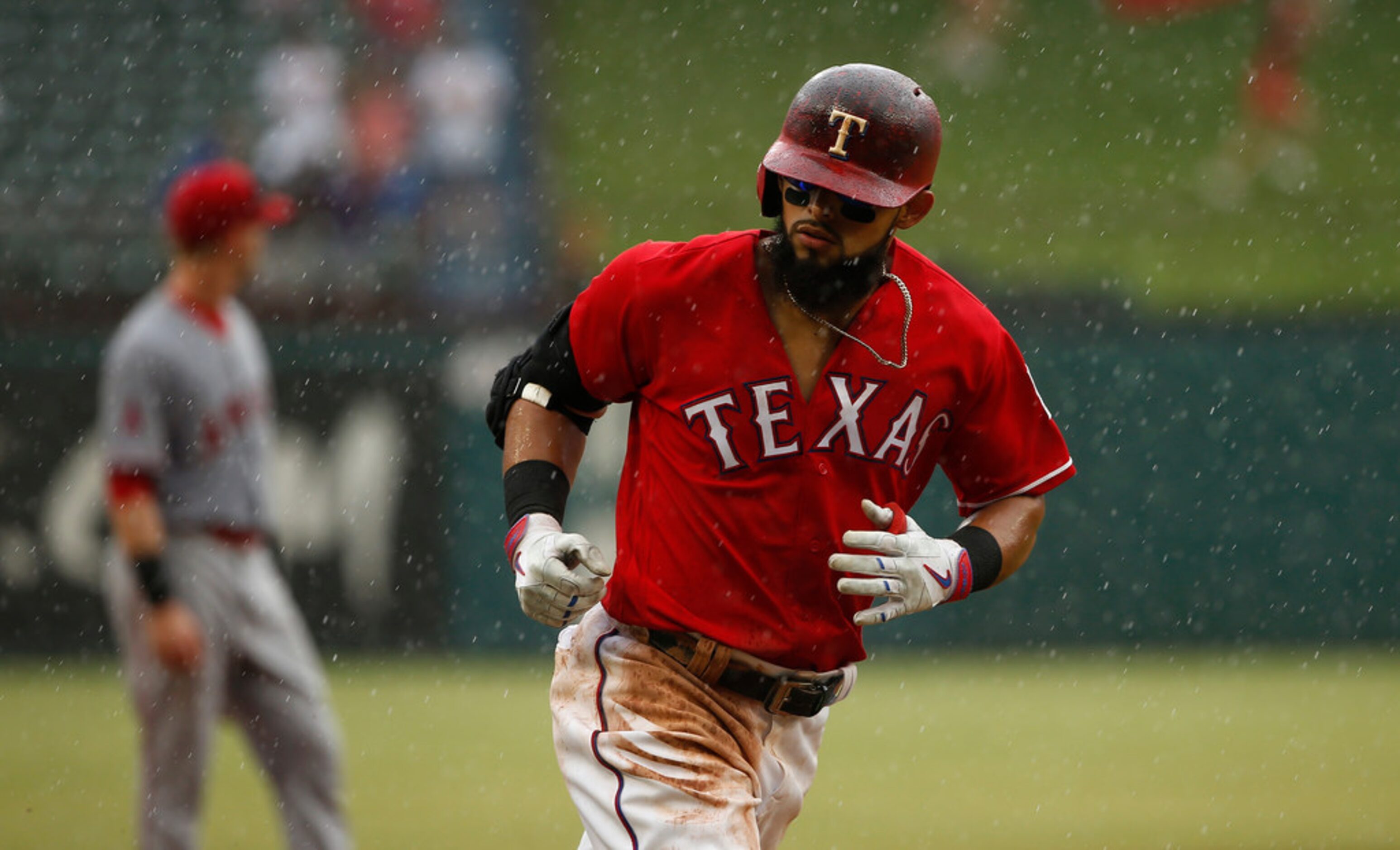 ARLINGTON, TX - AUGUST 19: Rougned Odor #12 of the Texas Rangers rounds third base after...