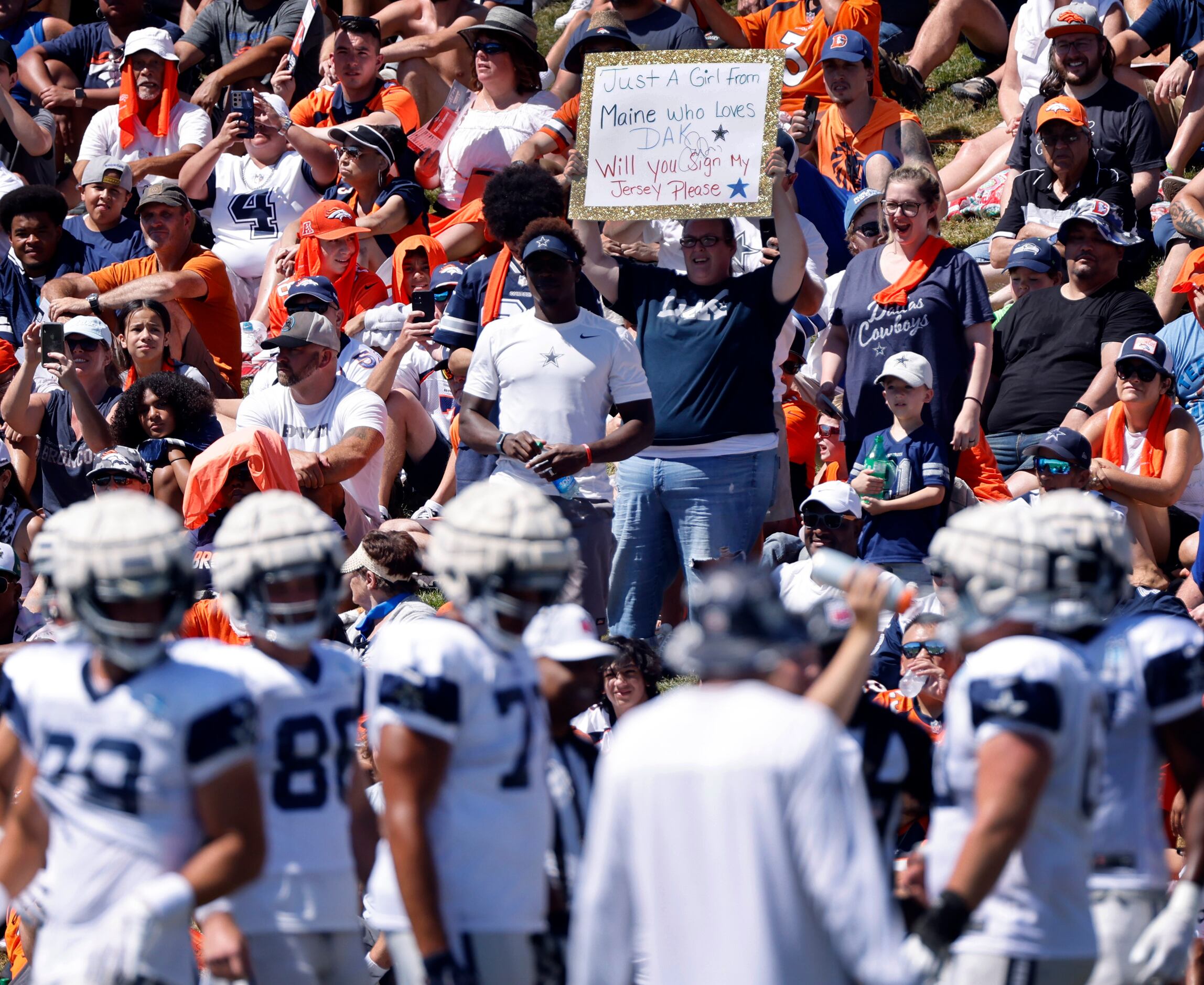 A Dallas Cowboys fan asks for quarterback Dak Prescott’s autograph on her jersey before a...