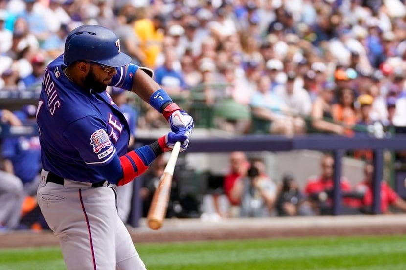 Texas Rangers' Elvis Andrus his a single during the first inning of a baseball game against...