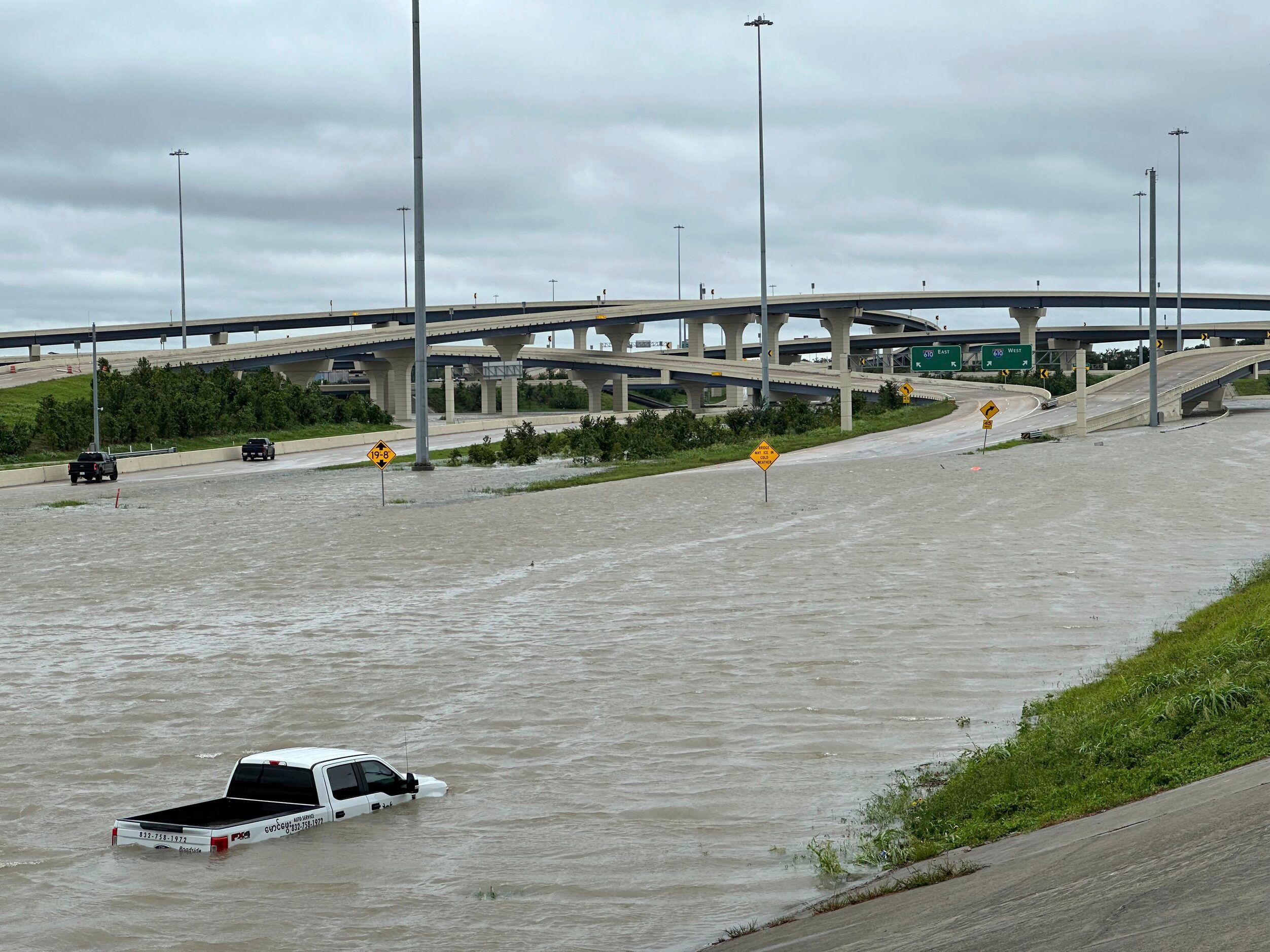 A vehicle is stranded in high waters on a flooded highway in Houston, on Monday, July 8,...