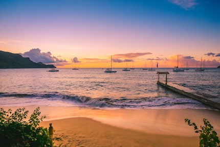 The sun sets off the coast of Bequia, a 7-square-mile island in the country of Saint Vincent...