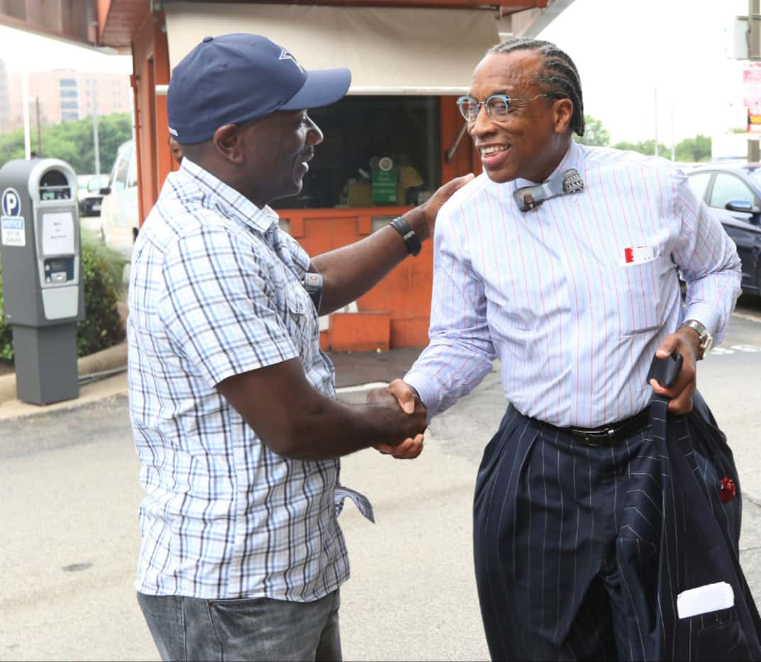 Dallas County Commissioner John Wiley Price talks with Jeff Hall, right, as he headings into...